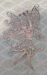 Fairy diecut covered with silver tinsel embossing powder.