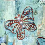 Handmade butterfly embellishment made with Stamperia Wonderland paper, gold gilding wax and faux pearls